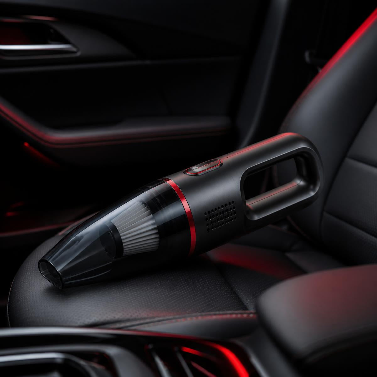 Compact cordless car vacuum on a dark leather car seat